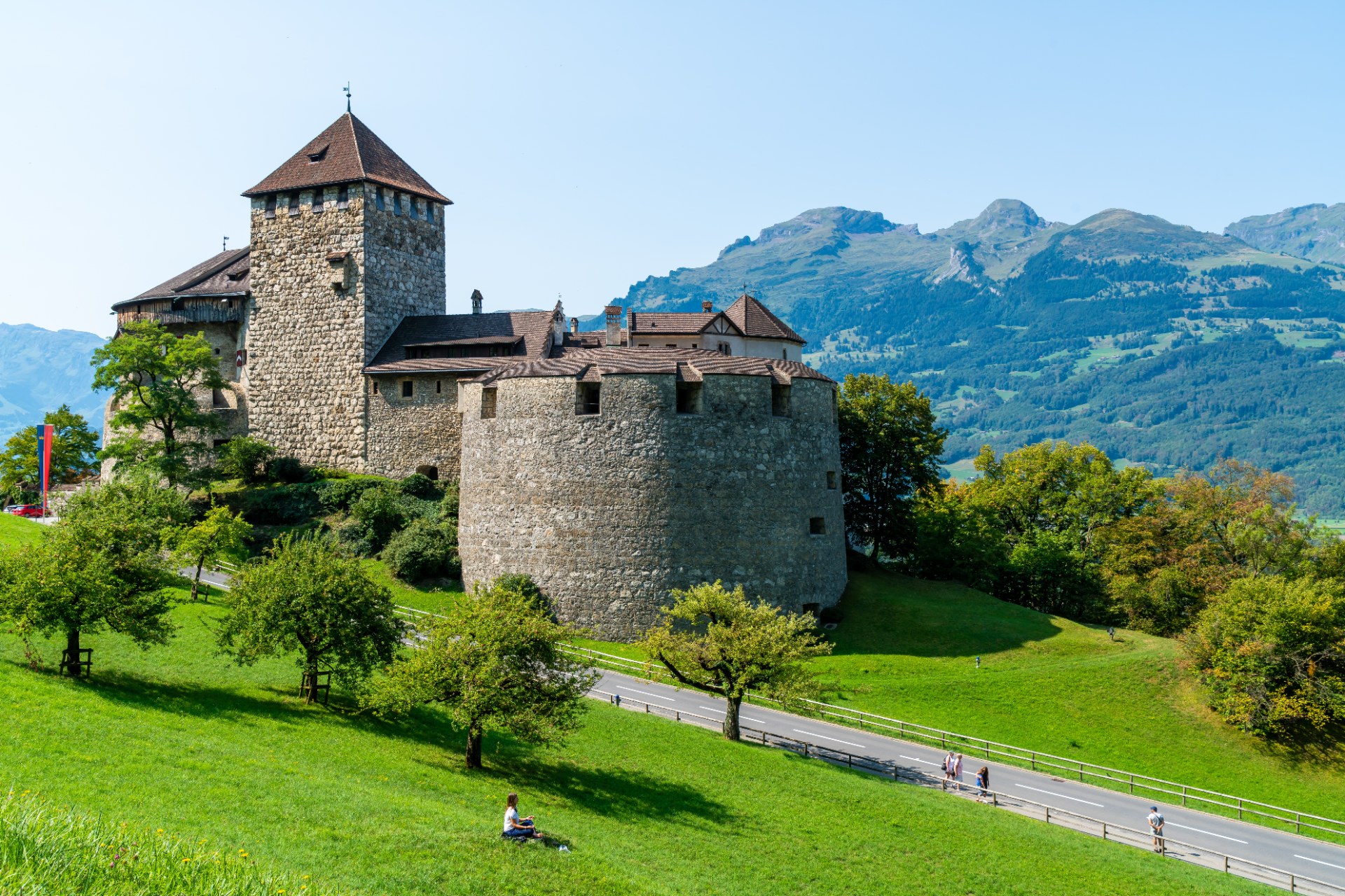 Vaduz Castle on a green hillside against the mountains in Liechtenstein